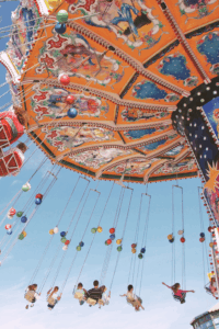 Enjoying carnival swing rides at the festival.