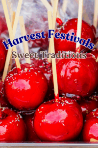 Bright red candy apples with sprinkles on sticks at a fall harvest festival.